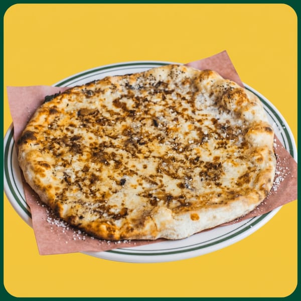 A round, cheesy flatbread with dark brown toppings and white sprinkles, on a white plate.